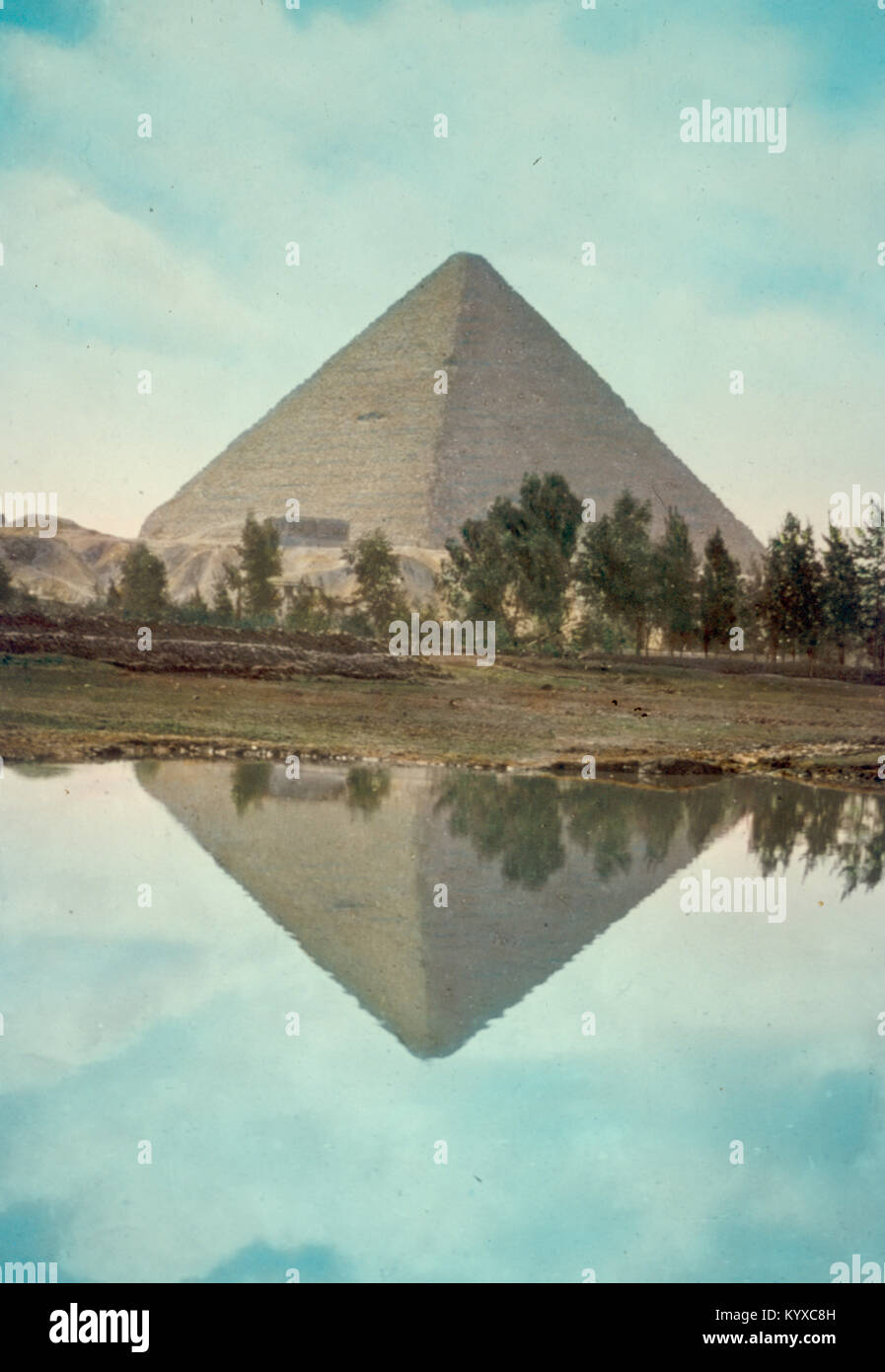 Pyramids. Great Pyramid of Cheops vividly reflected in Nile overflow Stock Photo