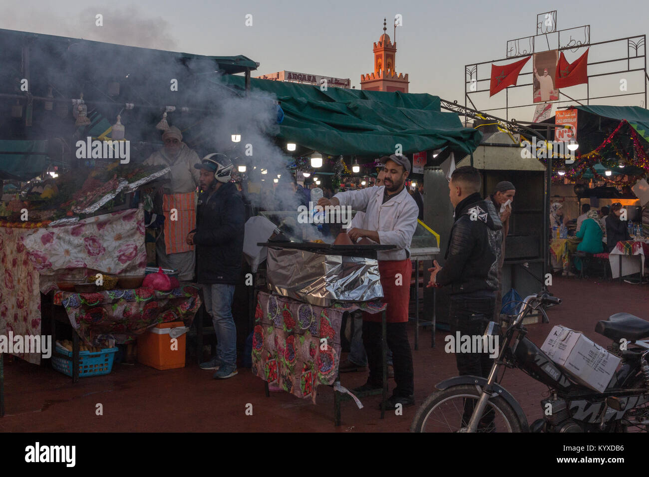 A man cooks meet on a bar-b-que in Jemaa el-Fnaa, Marrakesh, Morocco Stock Photo