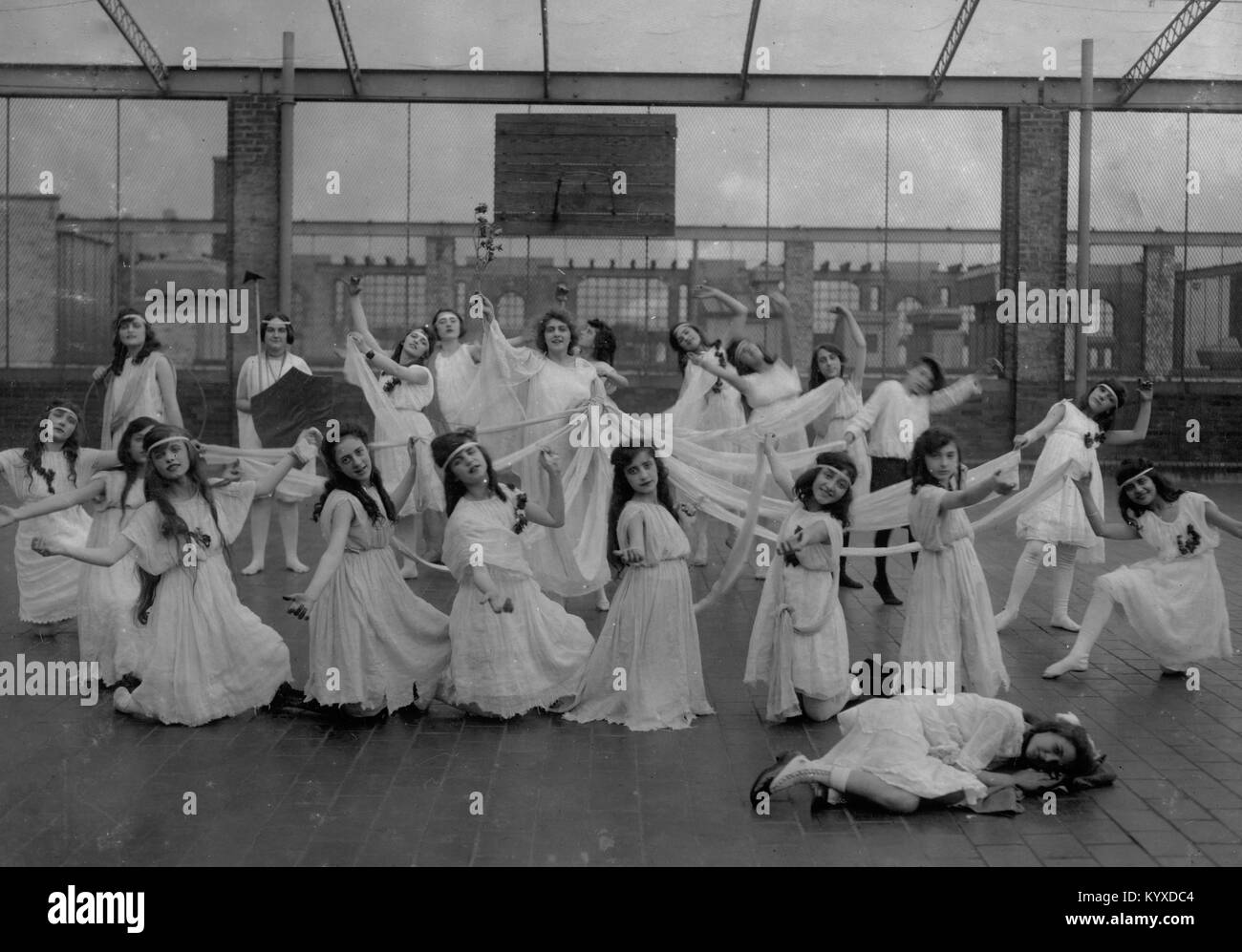 The dance of the Children of the Sunshine with Ellen sleeping in the foreground. Miss Mackay's Pageant Children of Sunshine and Shadow as presented at Washington Irving High School. Stock Photo