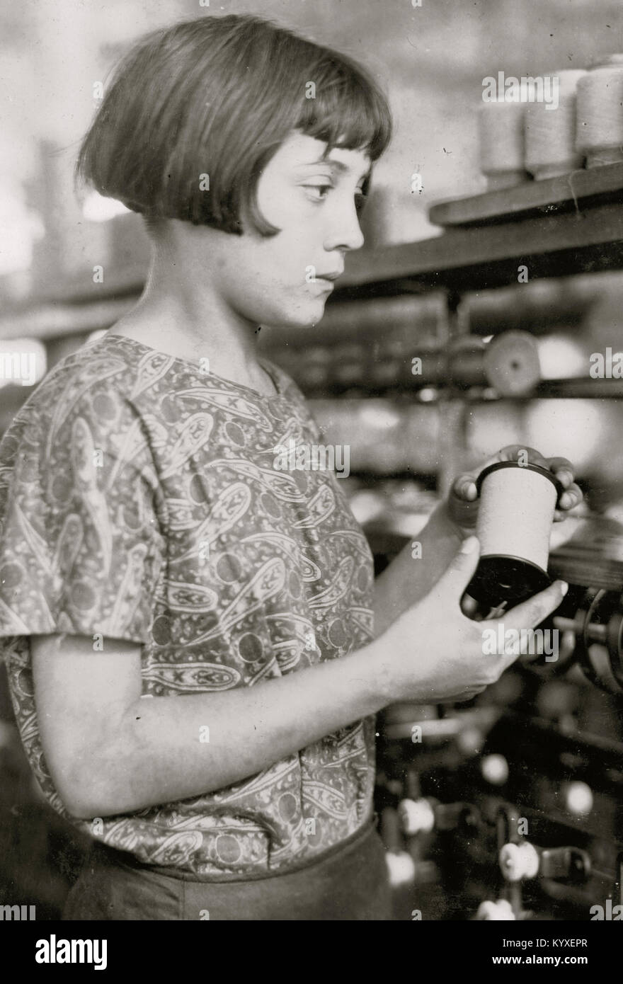 Girl holds a spool of silk thread Stock Photo