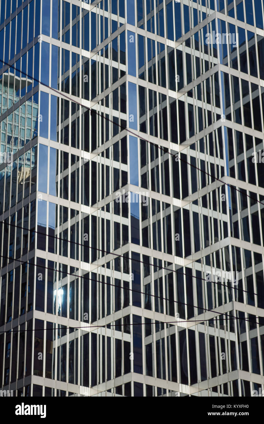 Closeup of a modern glass and steel skyscraper facade, with reflections, in downtown Vancouver, Canada Stock Photo