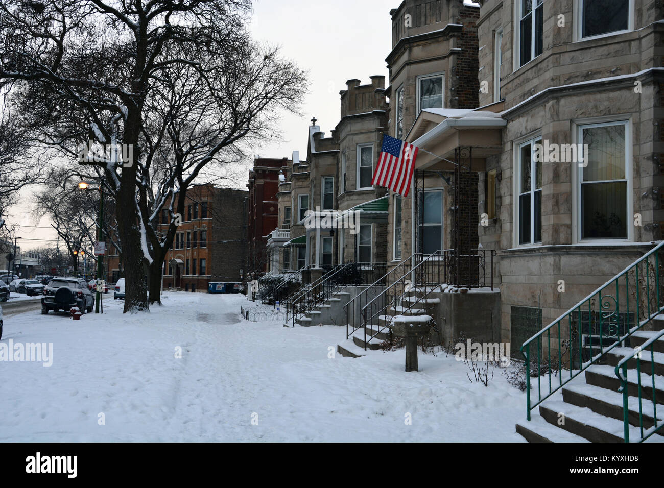 Fresh snow covers the sidewalk in front of typical Chicago style two-flat homes in the Lincoln Square neighborhood, small flats make up 30% of housing Stock Photo