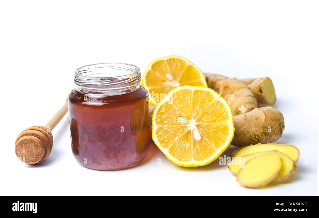 Jar of honey and lemon, gingers isolated on white background. Stock Photo