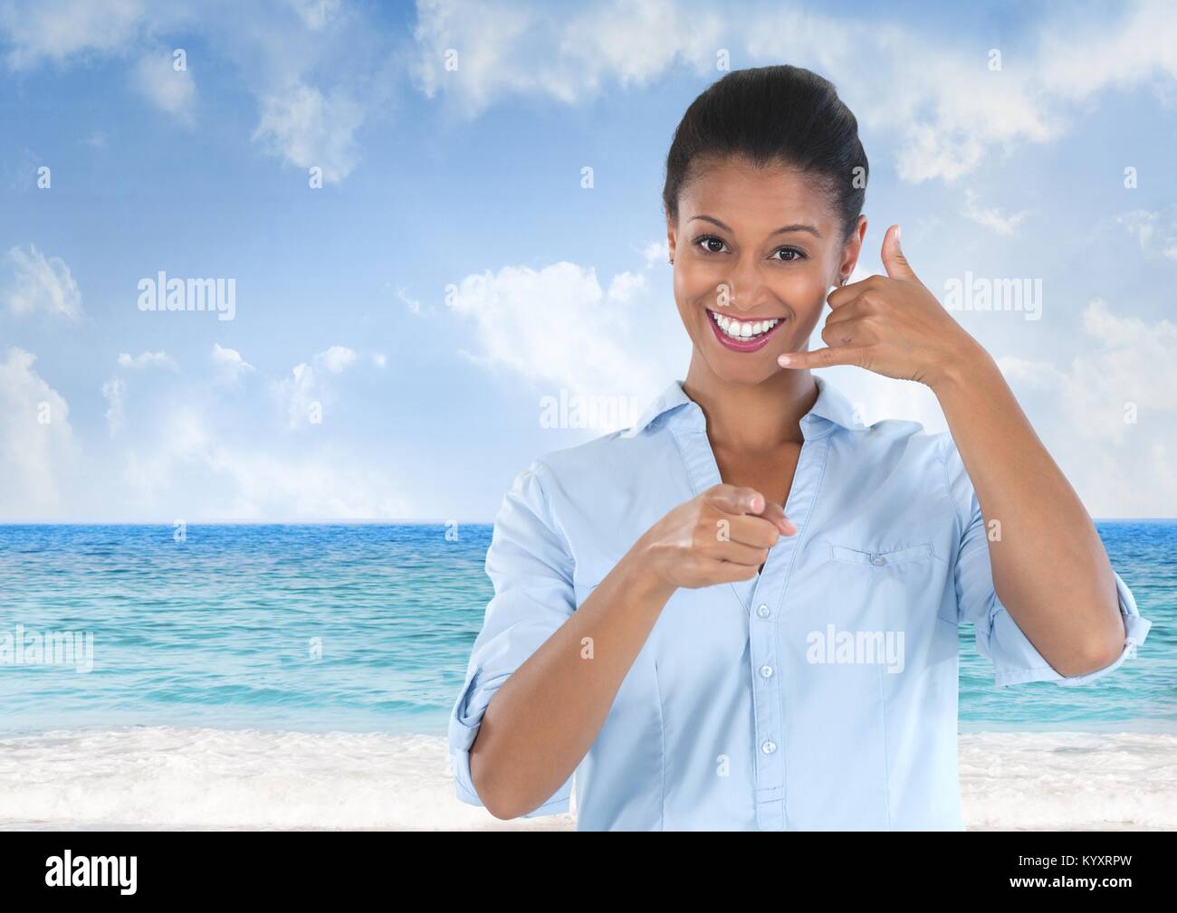 woman smiling and pointing with ring me sign Stock Photo