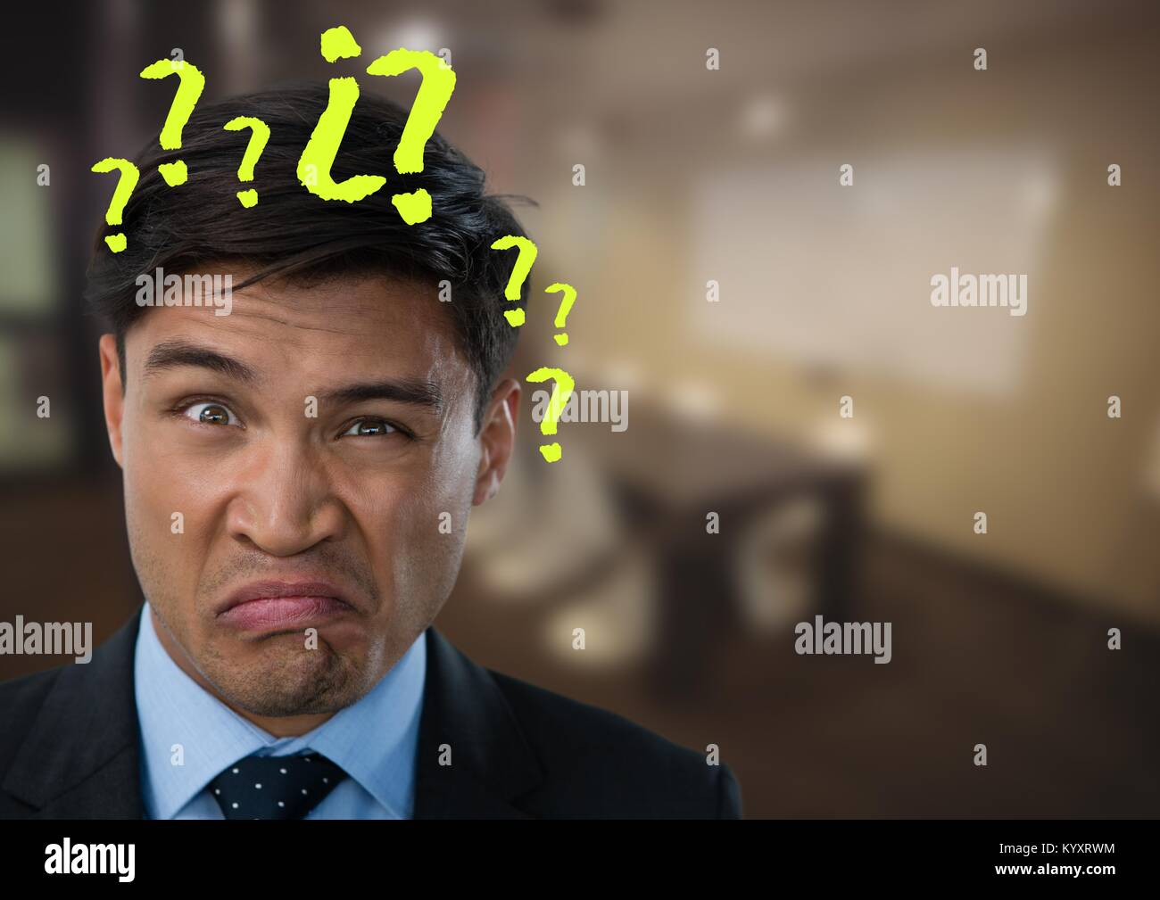 Confused or disgusted man in an office with question marks Stock Photo