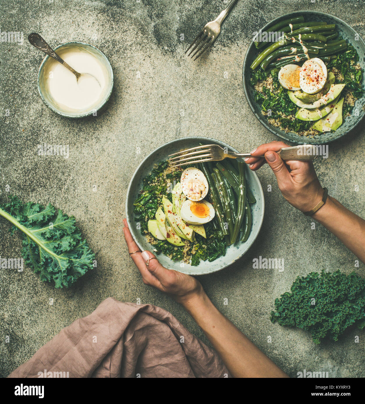 Quinoa, kale, beans, avocado, egg bowls flatlay, top view Stock Photo