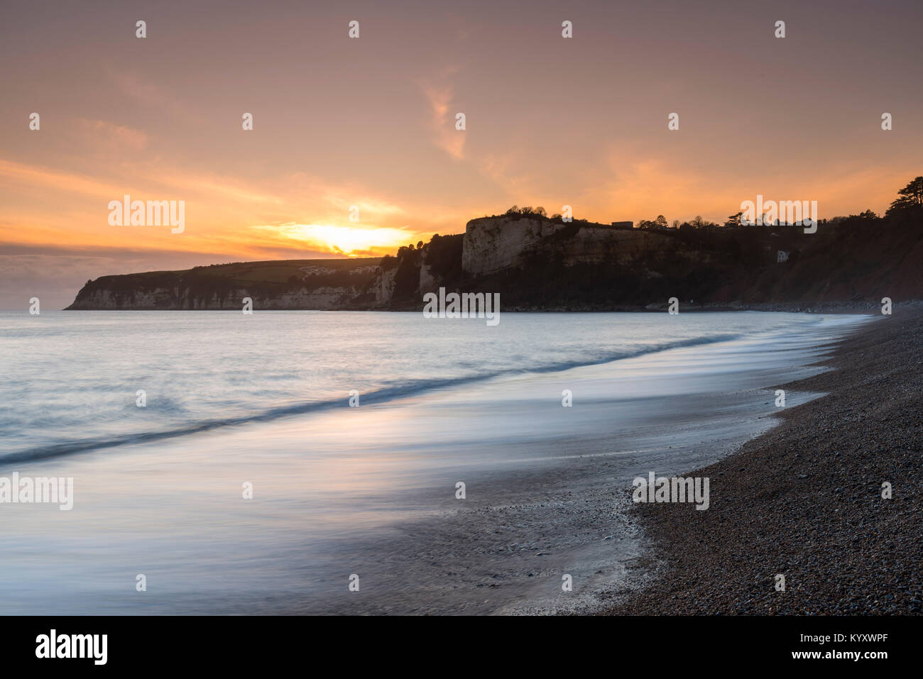 Seaton, Devon, UK. 10th January 2018.  UK Weather.  Sunset viewed from the beach at Seaton in Devon looking towards Beer.  Picture Credit: Graham Hunt Stock Photo