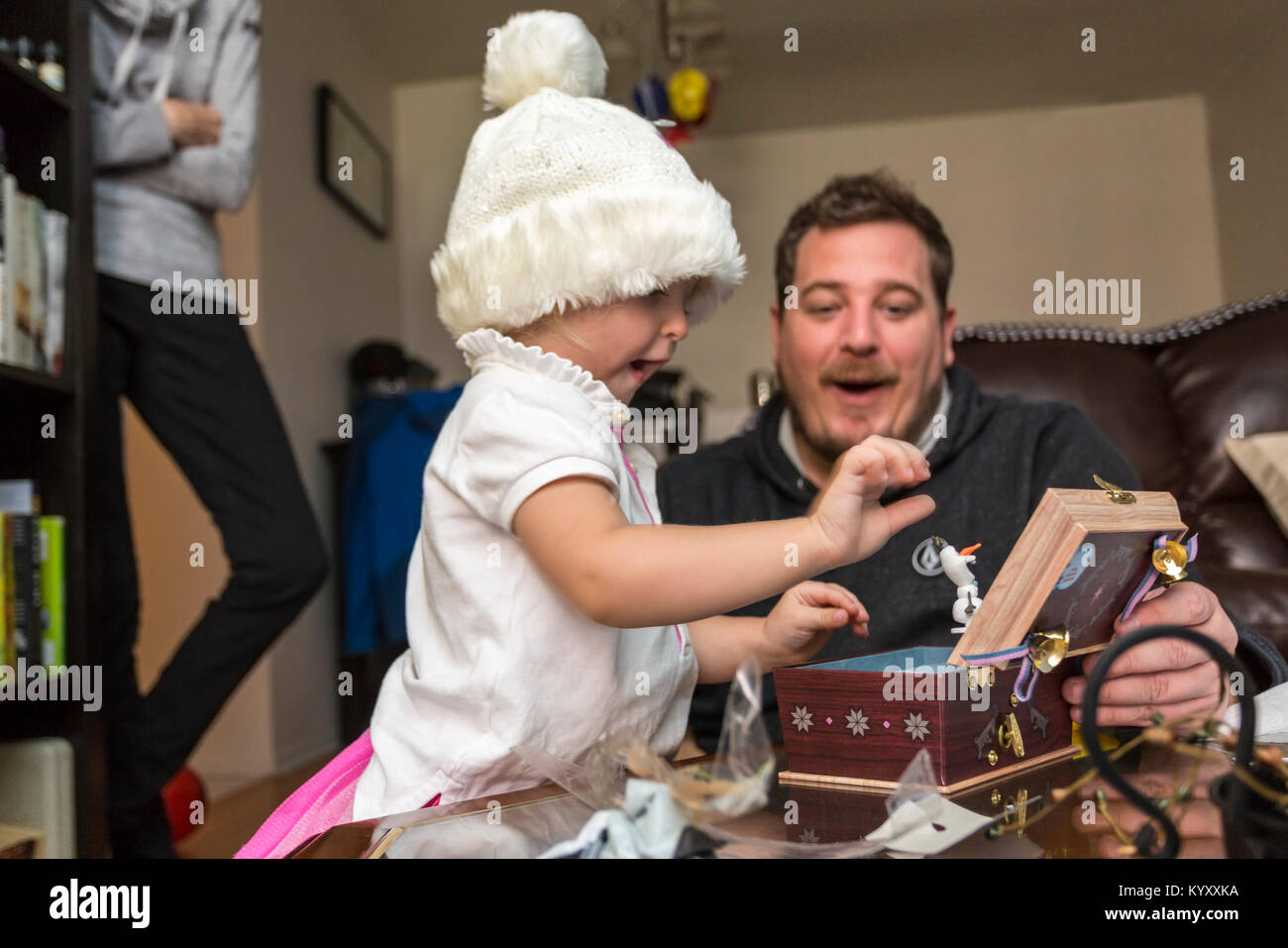 father and child playing with music box Stock Photo