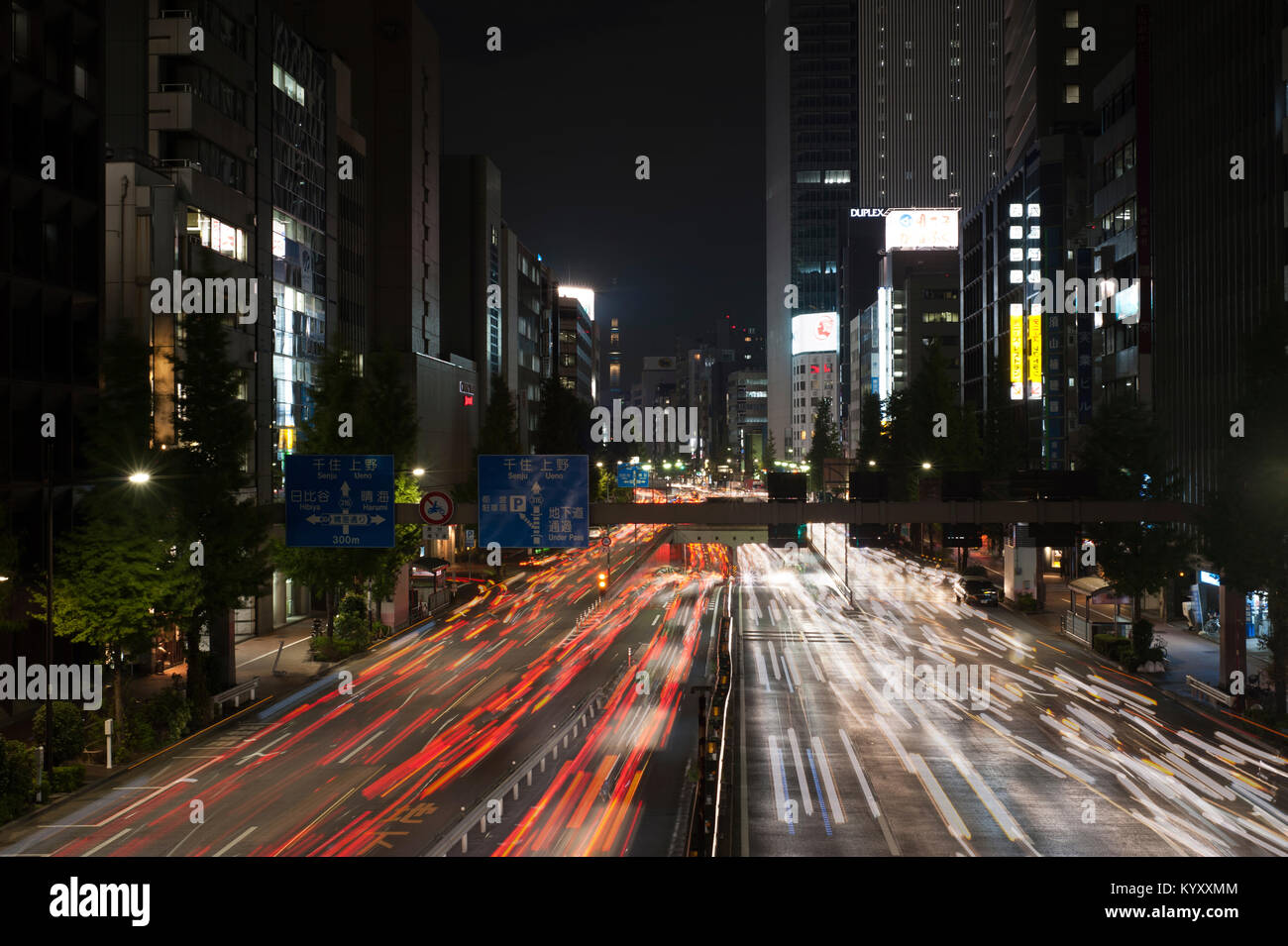 High angle view of traffic light trails on city street with Tokyo Sky Tree in background Stock Photo