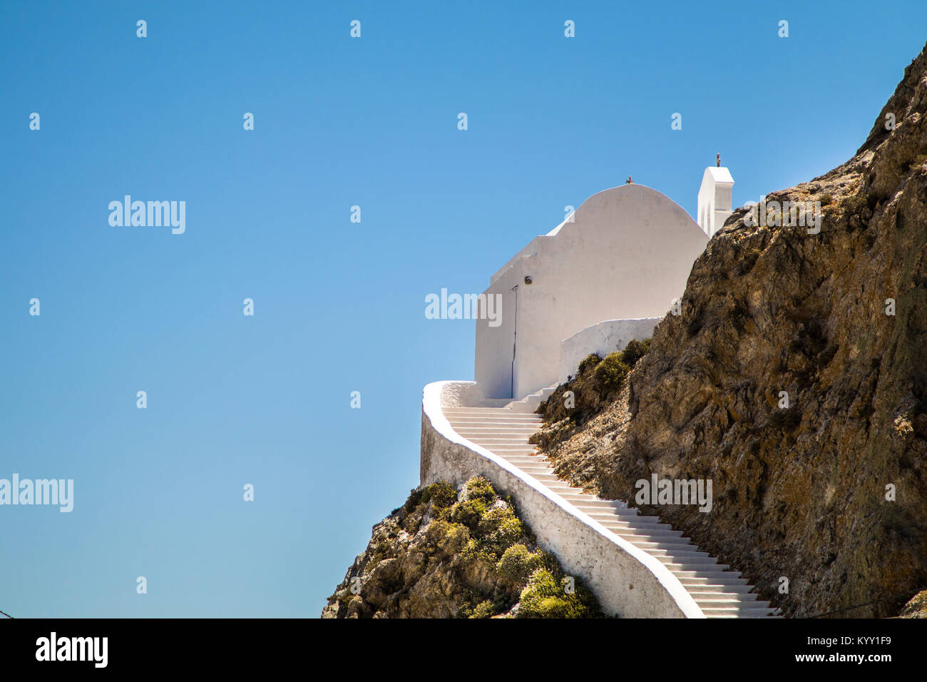 Low angle view of church on mountain against clear blue sky Stock Photo