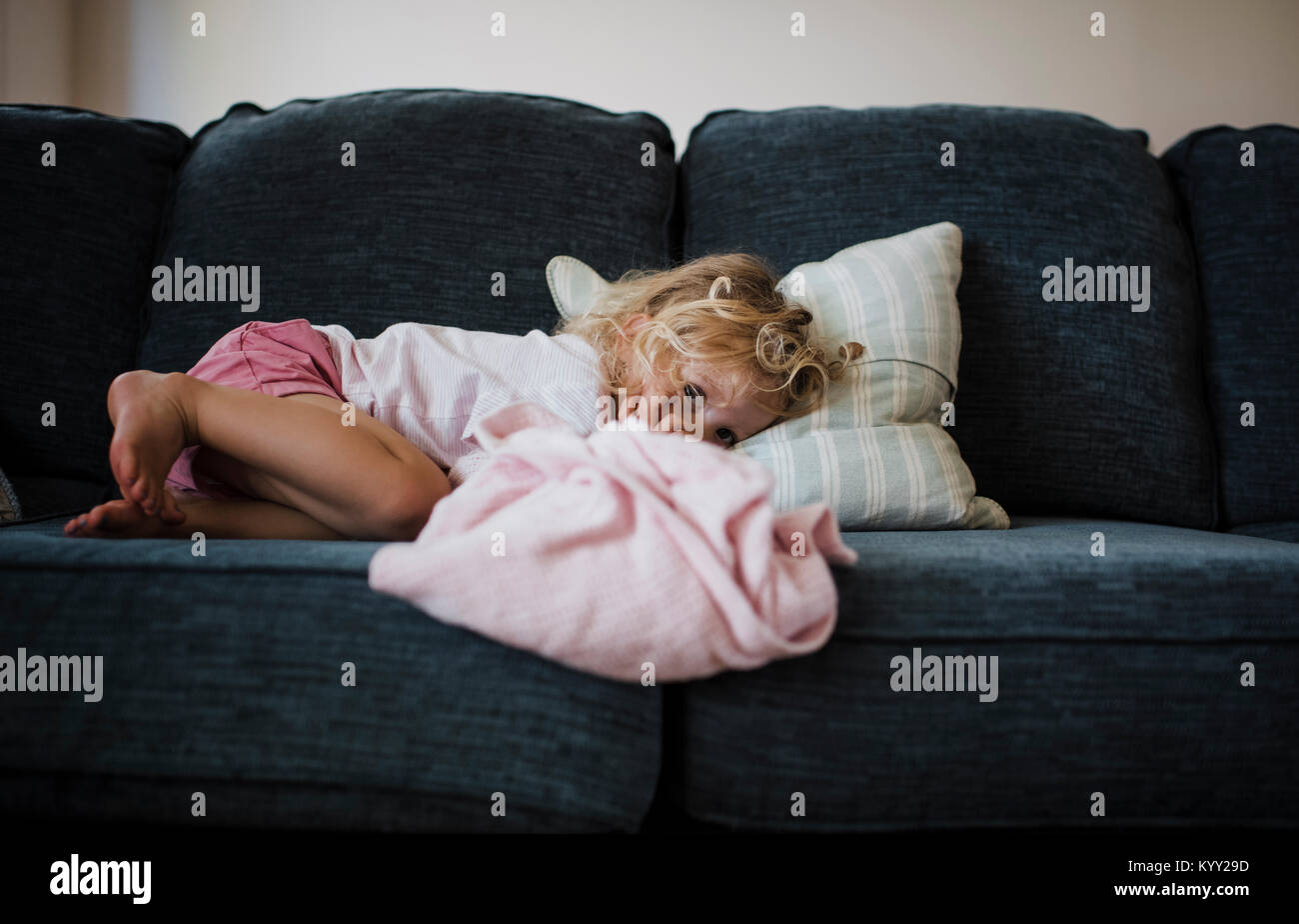 Portrait of girl lying on sofa at home Stock Photo Alamy