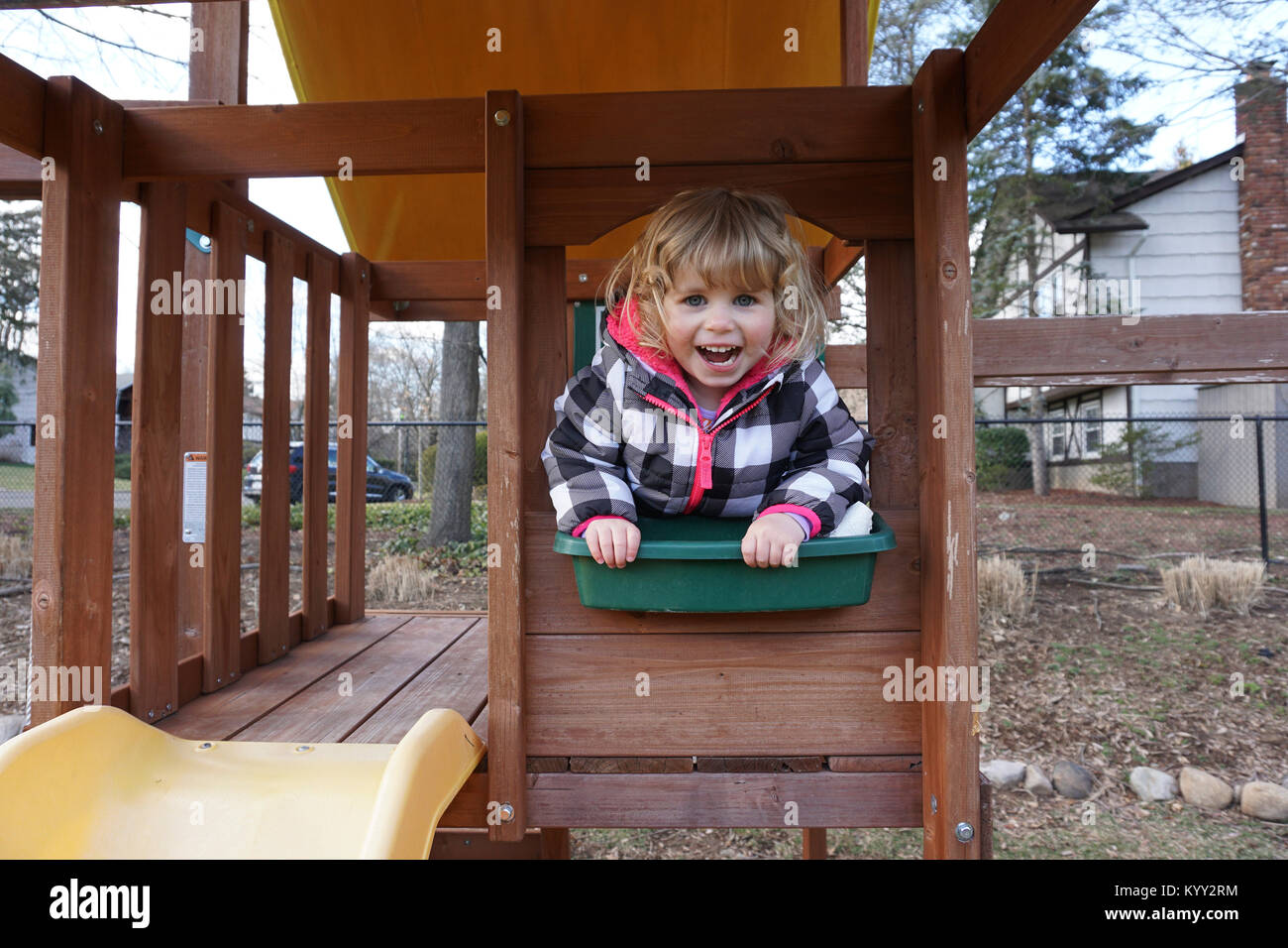 Portrait of happy girl playing on outdoor play equipment at playground Stock Photo
