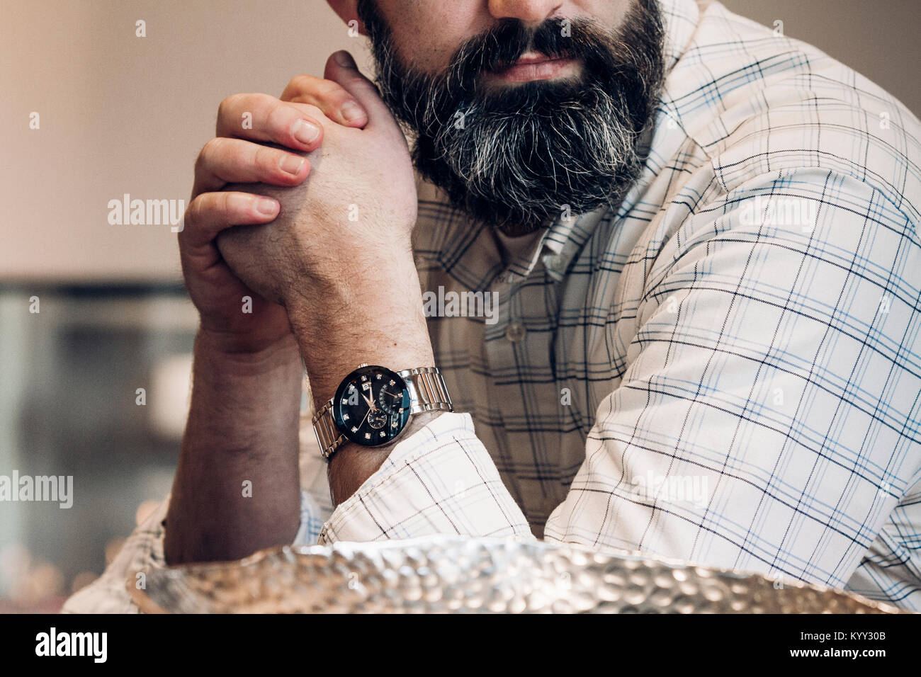 Midsection of businessman with hands clasped in hotel Stock Photo