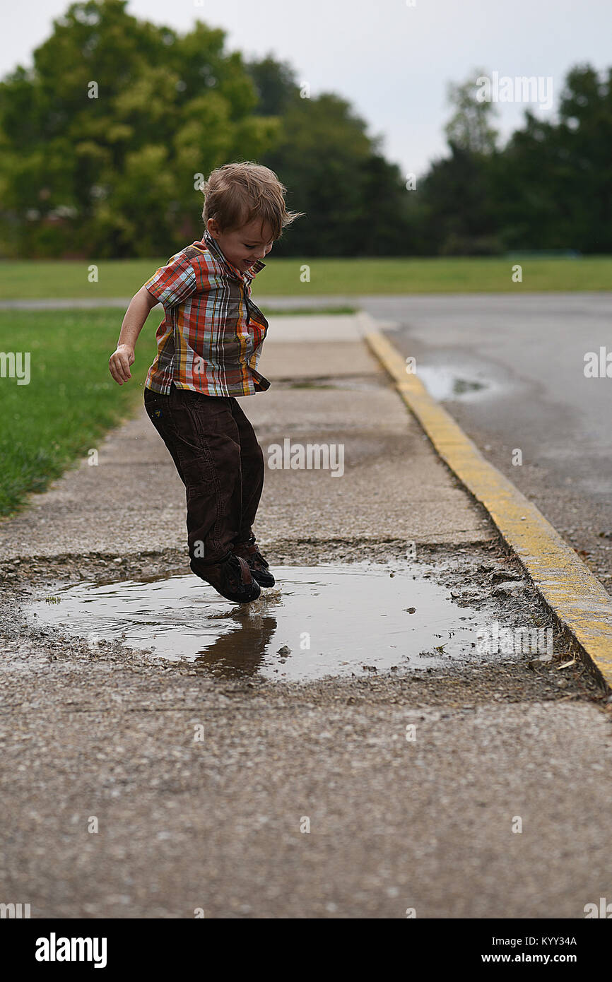 Boy jumping in puddle hires stock photography and images Alamy