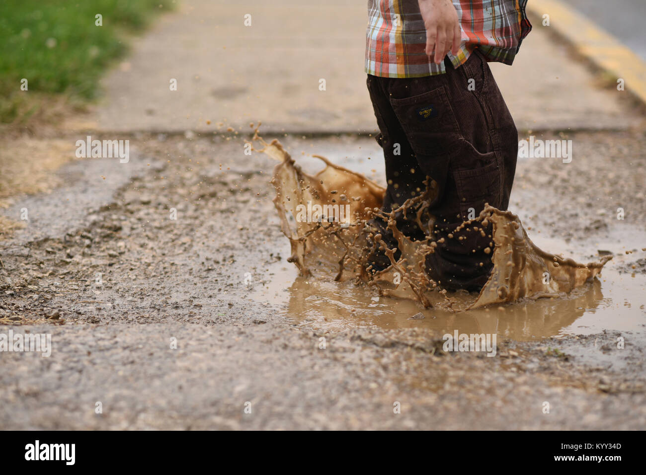 Boy jumping in puddle hi-res stock photography and images - Alamy