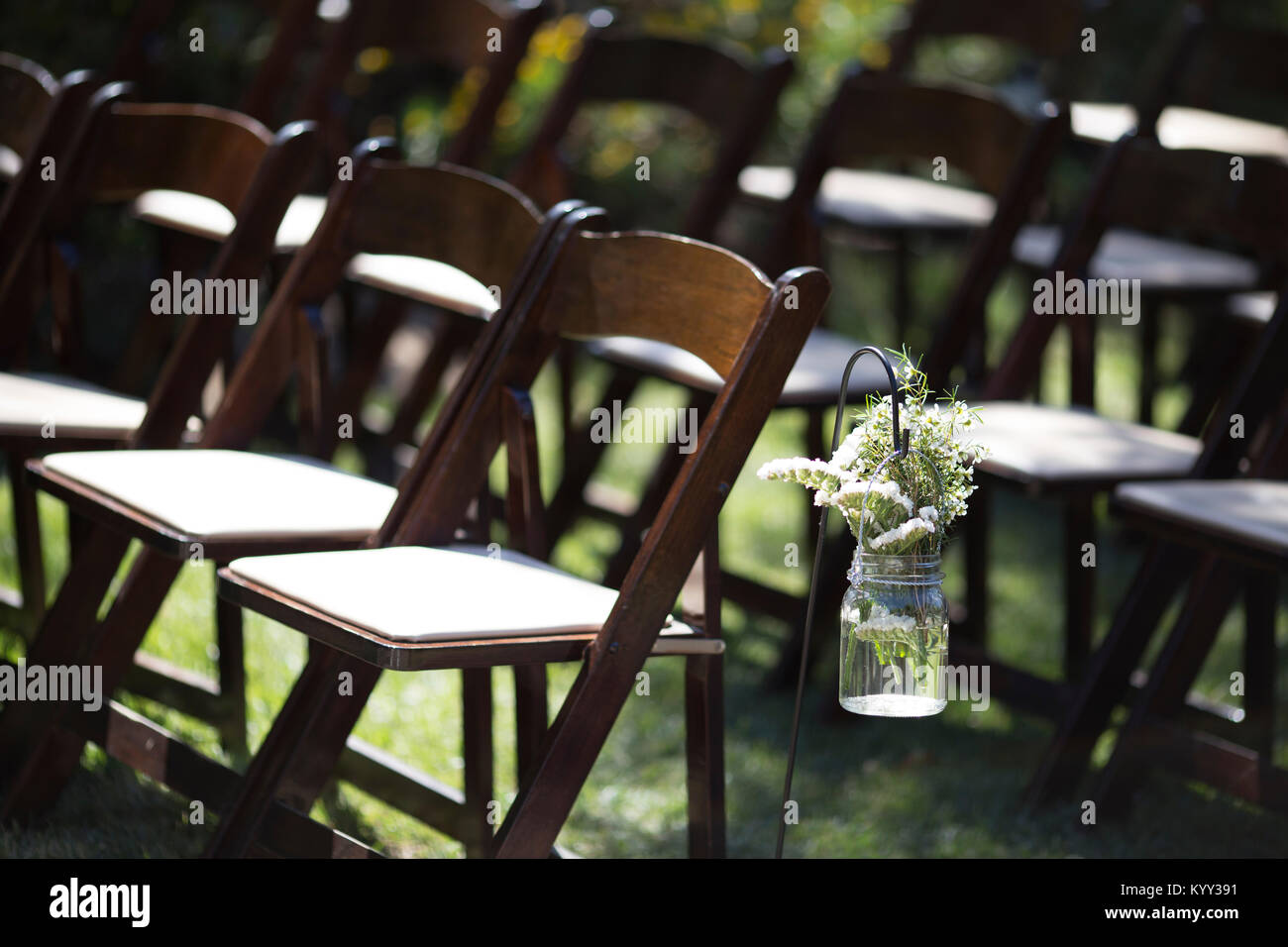 Empty wedding chairs arranged at field Stock Photo