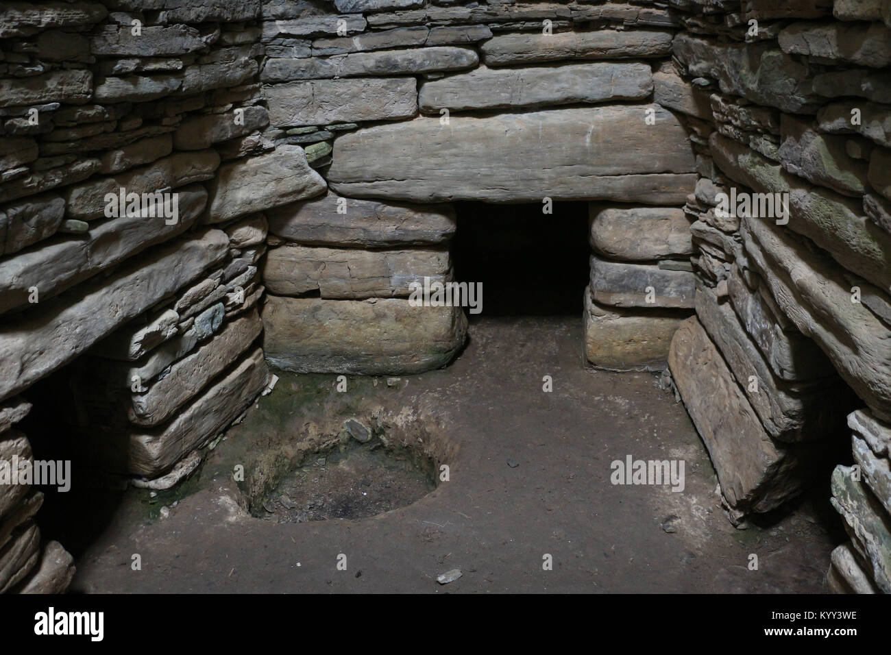 The interior main chamber of Quoyness cairn, located on Sanday Island in Orkney, Scotland. Entrances to 3 of the 6 side cells can be seen here. Stock Photo