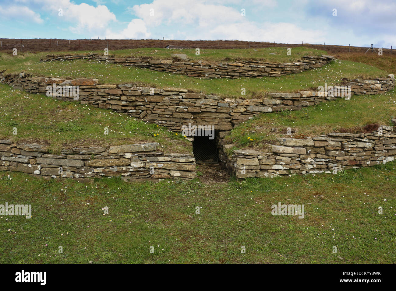 The Wideford Hill chambered cairn is reached after a 20 minute hike down a path. It has three terraces, central chamber and 3 side cells. Great views. Stock Photo
