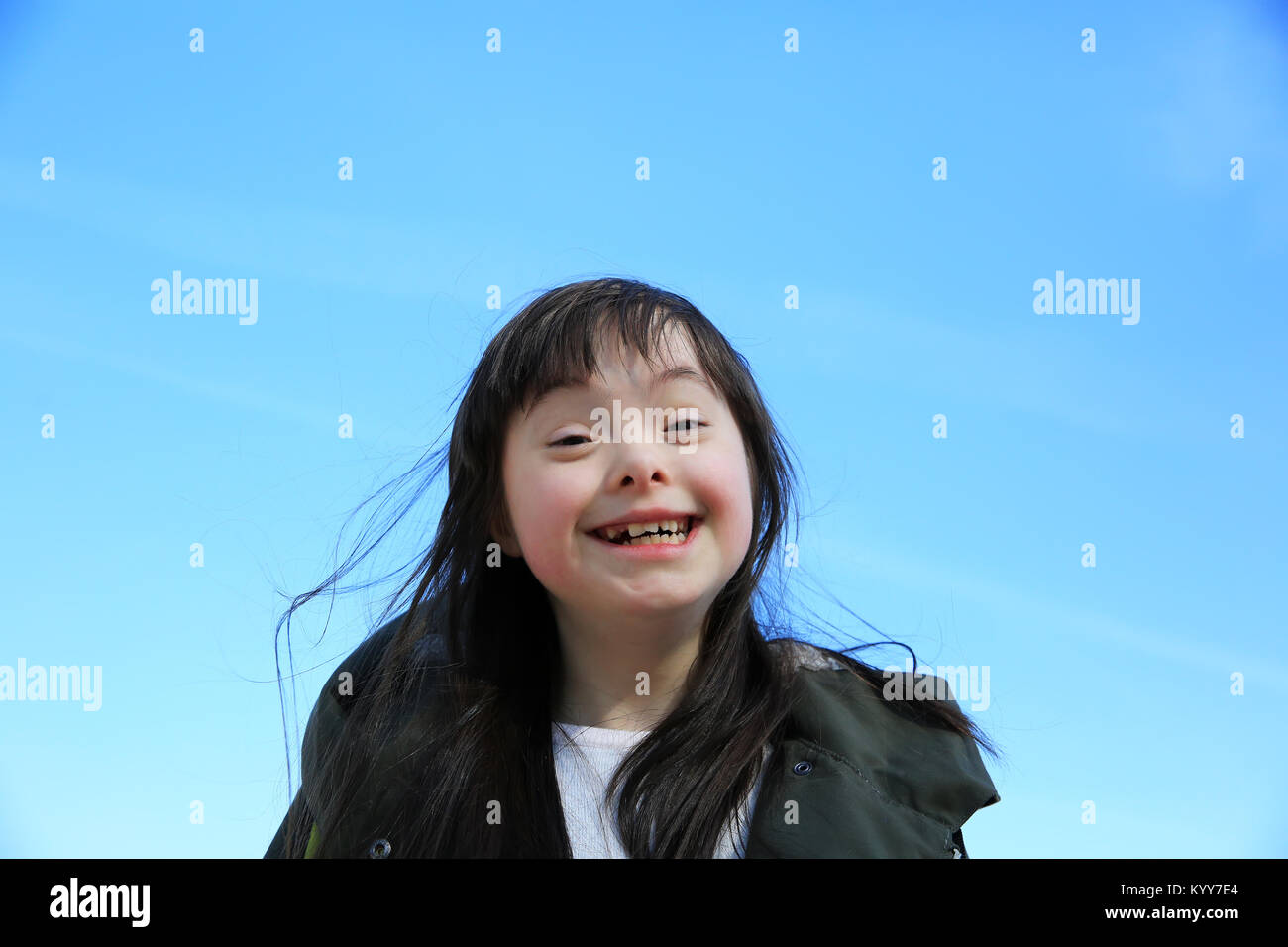 Portrait of little girl smiling on background of the blue sky Stock ...