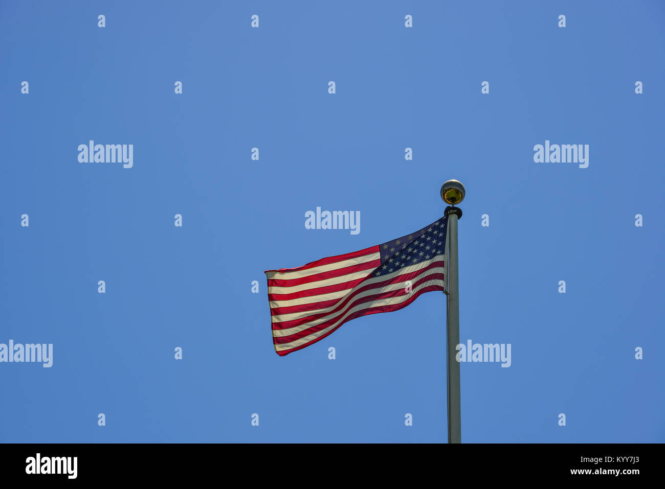 American flag waving in the blue sky at sunny day Stock Photo - Alamy