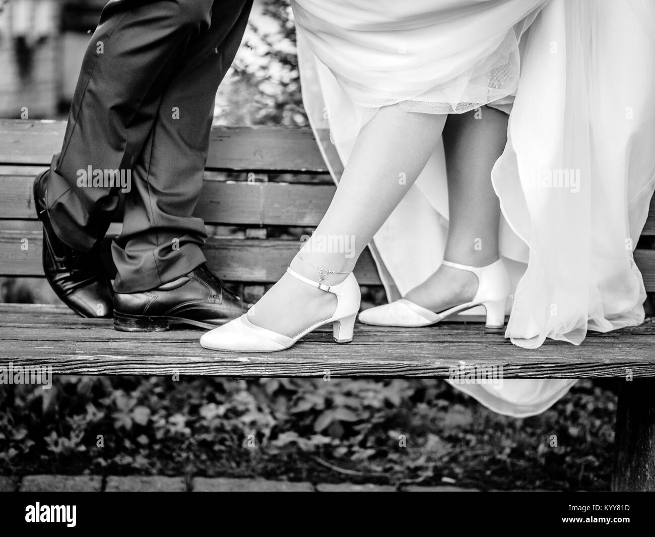 the bride and groom on the bench Stock Photo