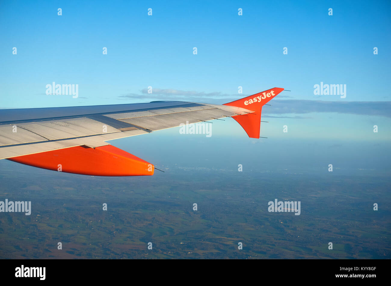 An Easyjet aircraft wing in flight seen from the cabin. Stock Photo