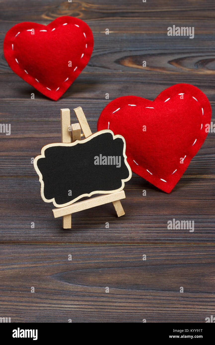 Red heart and small blackboard with copy space on a black background ...
