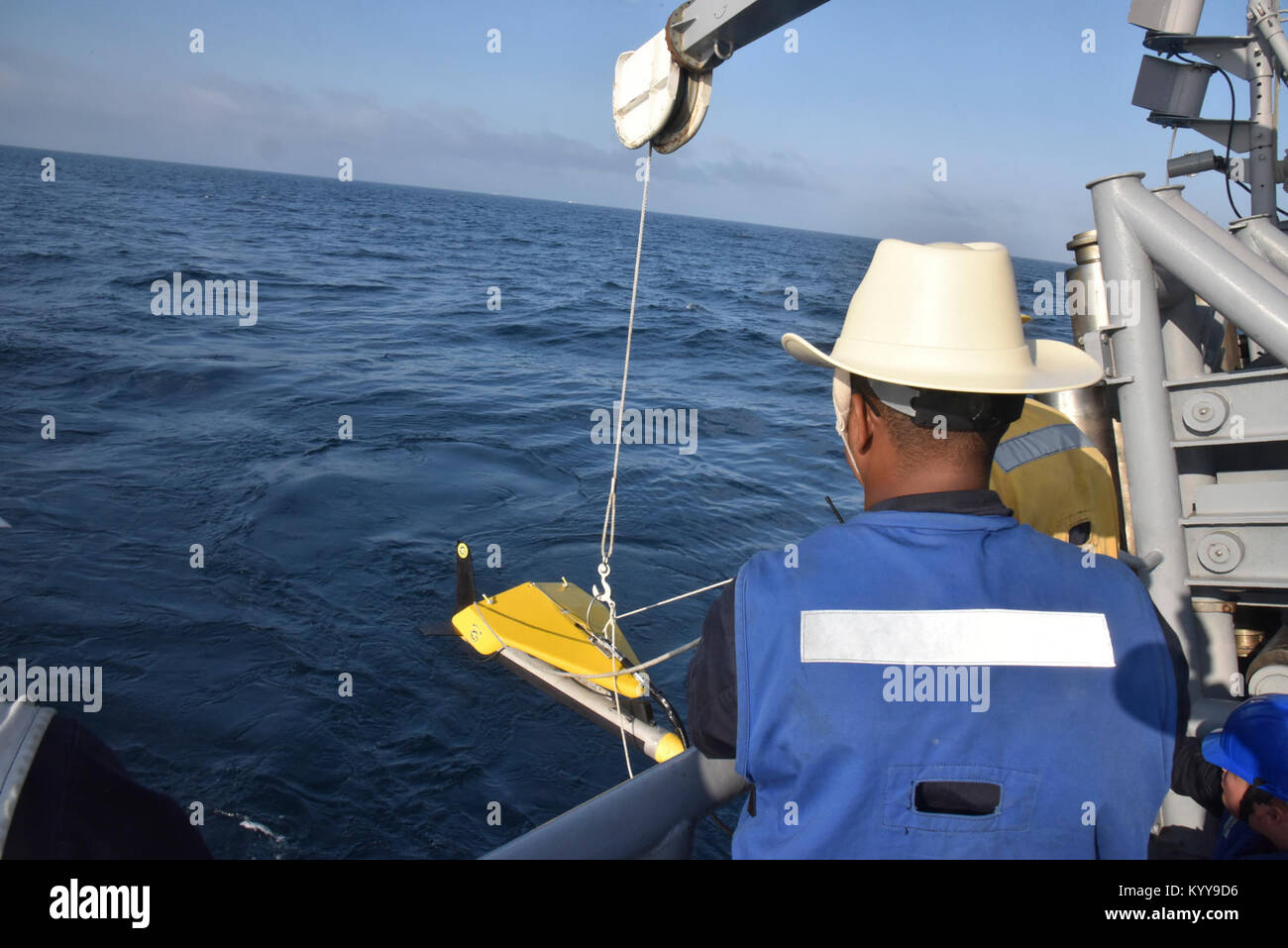 LOS ANGELES (SEPT. 6, 2017) A Sailor attached to Avenger-class mine countermeasure ship USS Champion (MCM 4) uses tending lines to steady the Klein 5,000, a side-scan sonar device used to survey the ocean floor, as it is lowered into the water by an articulating crane during launch operations on the Champion fantail while off the coast of Southern California. The evolution allowed the Champion to use sonar technology in order to develop an understanding of the seabed topography.  (U.S. Navy Stock Photo