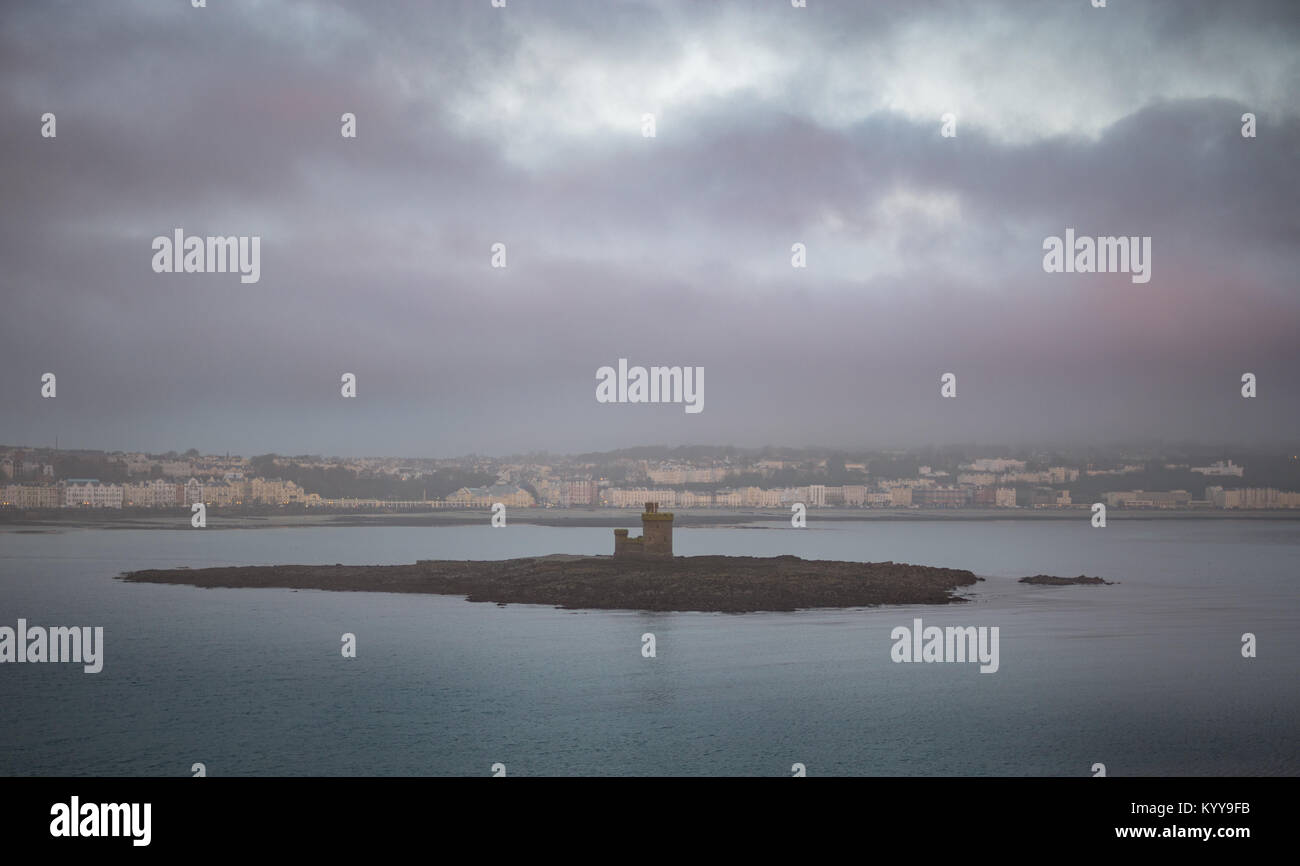 Tower of Refuge and Douglas bay in the morning mist, view from the sea Stock Photo