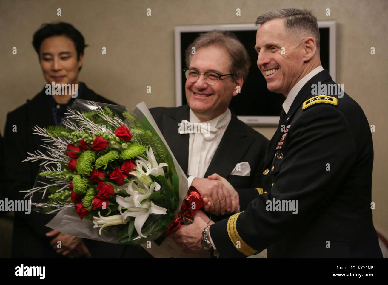 U.S Army Lt. Gen. Thomas S. Vandal commander of the Eighth army, presents flowers to Carl Palleschi after the Holiday concert in Seoul, Korea Dec. 17, 2017. The concert was hosted by the Eighth Army command in conjunction with local community leaders during the holiday season to promote harmonious relations between the U.S. Army and the Republic of Korea (ROK). Over 1500 U.S. Soldiers and ROK soldiers attended performances by the Eighth Army Band and the Prime Philharmonic Orchestra . (U.S. Army Stock Photo