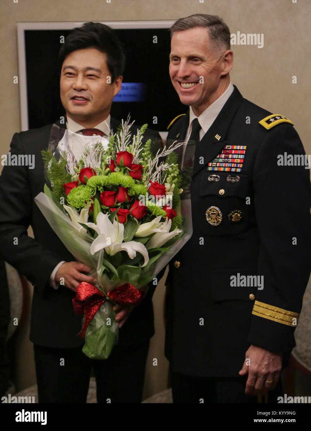 U.S Army Lt. Gen. Thomas S. Vandal commander of the Eighth army, presents flowers to Seo, Jung-Hak after the Holiday concert in Seoul, Korea Dec. 17, 2017. The concert was hosted by the Eighth Army command in conjunction with local community leaders during the holiday season to promote harmonious relations between the U.S. Army and the Republic of Korea (ROK). Over 1500 U.S. Soldiers and ROK soldiers attended performances by the Eighth Army Band and the Prime Philharmonic Orchestra . (U.S. Army Stock Photo