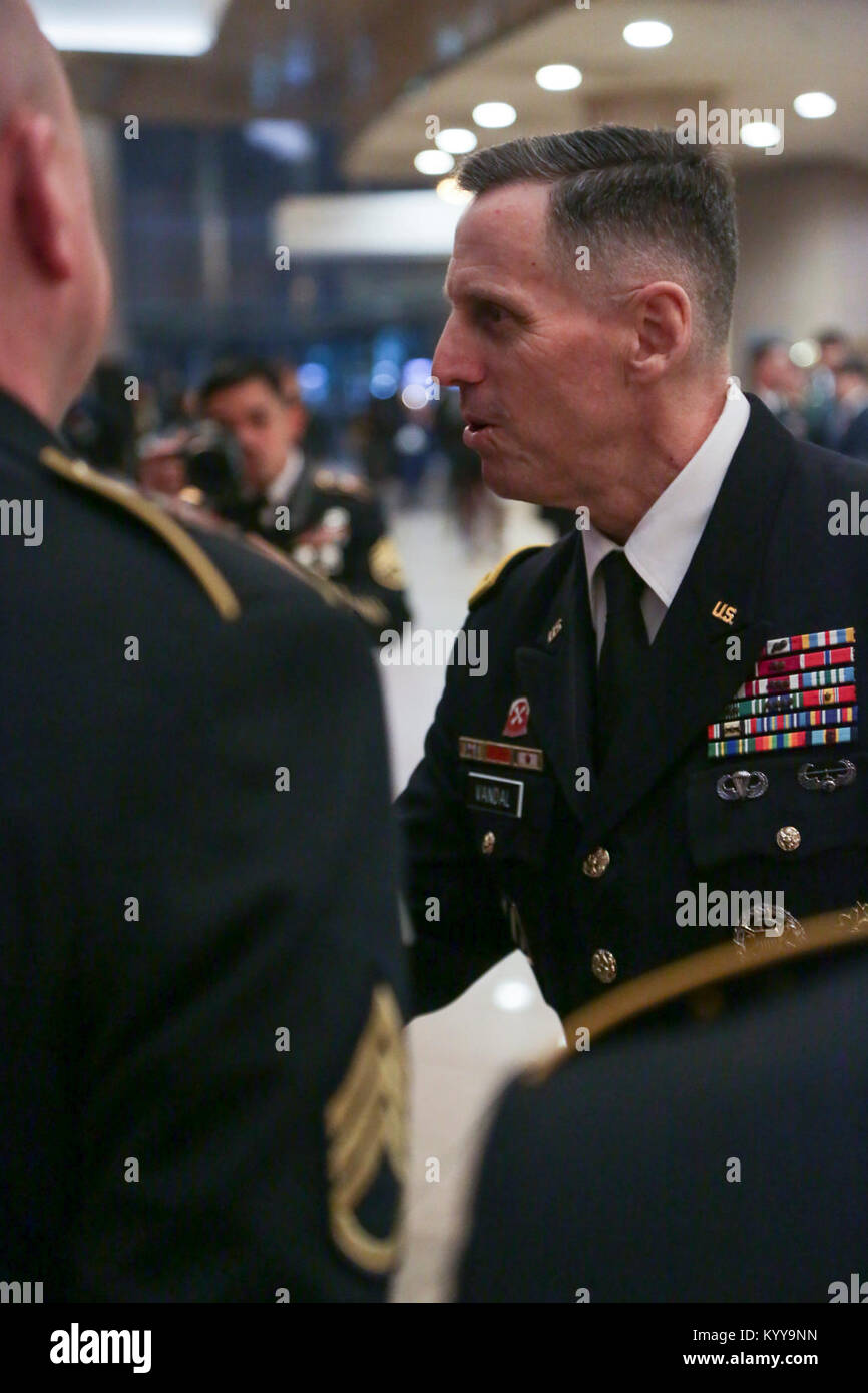 U.S Army Lt. Gen. Thomas S. Vandal commander of the Eighth army, presents coins to the Eighth Army Band after the Holiday concert in Seoul, Korea Dec. 17, 2017. The concert was hosted by the Eighth Army command in conjunction with local community leaders during the holiday season to promote harmonious relations between the U.S. Army and the Republic of Korea (ROK). Over 1500 U.S. Soldiers and ROK soldiers attended performances by the Eighth Army Band and the Prime Philharmonic Orchestra . (U.S. Army Stock Photo