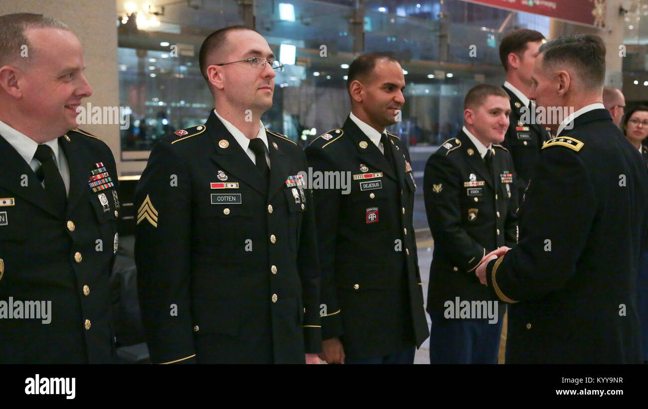 U.S Army Lt. Gen. Thomas S. Vandal commander of the Eighth army, presents coins to the Eighth Army Band after the Holiday concert in Seoul, Korea Dec. 17, 2017. The concert was hosted by the Eighth Army command in conjunction with local community leaders during the holiday season to promote harmonious relations between the U.S. Army and the Republic of Korea (ROK). Over 1500 U.S. Soldiers and ROK soldiers attended performances by the Eighth Army Band and the Prime Philharmonic Orchestra . (U.S. Army Stock Photo