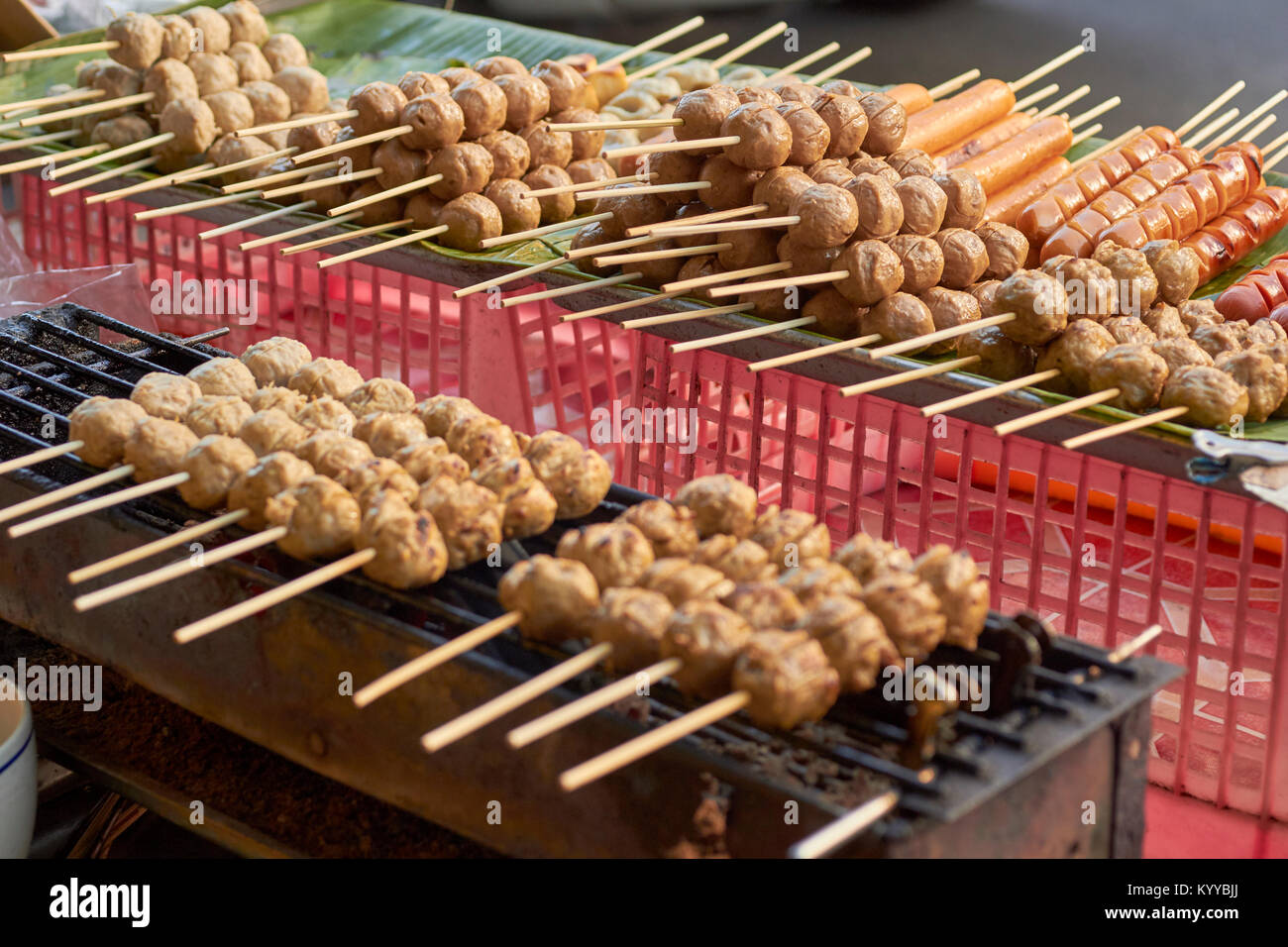 meat skewers grilling at a street market, Chinatown, Chiang Mai, Thailand Stock Photo