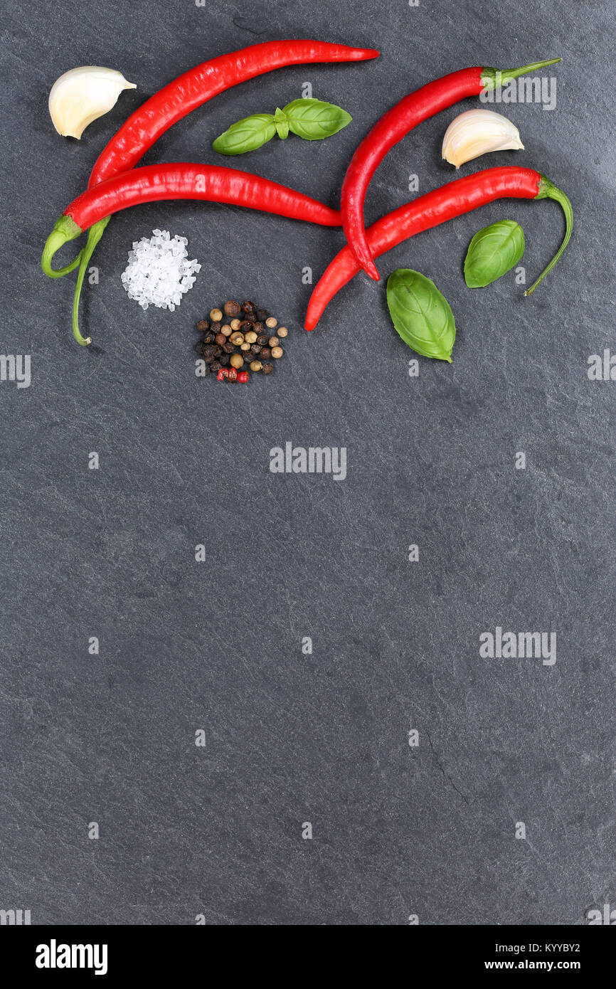 Red hot chili peppers chilli cooking ingredients portrait format copyspace slate top view from above Stock Photo