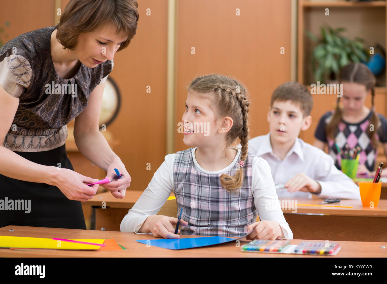 Labour Lesson School children working at labour lesson. Teacher helping pupil Stock ...