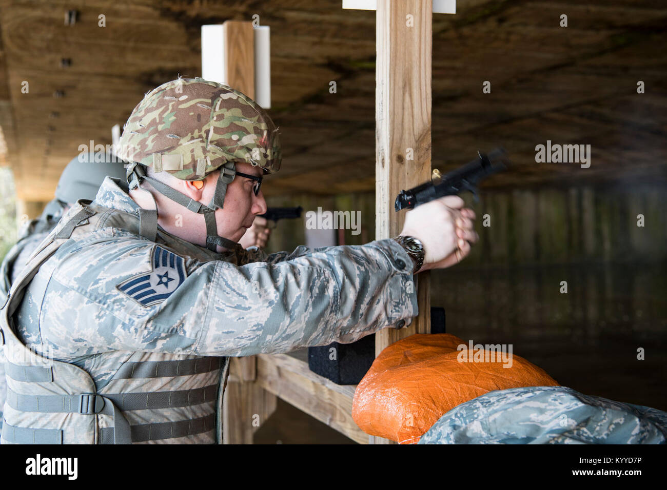 U.S. Air Force Staff Sgt. Nathan Parsons shoots the Beretta M9 handgun