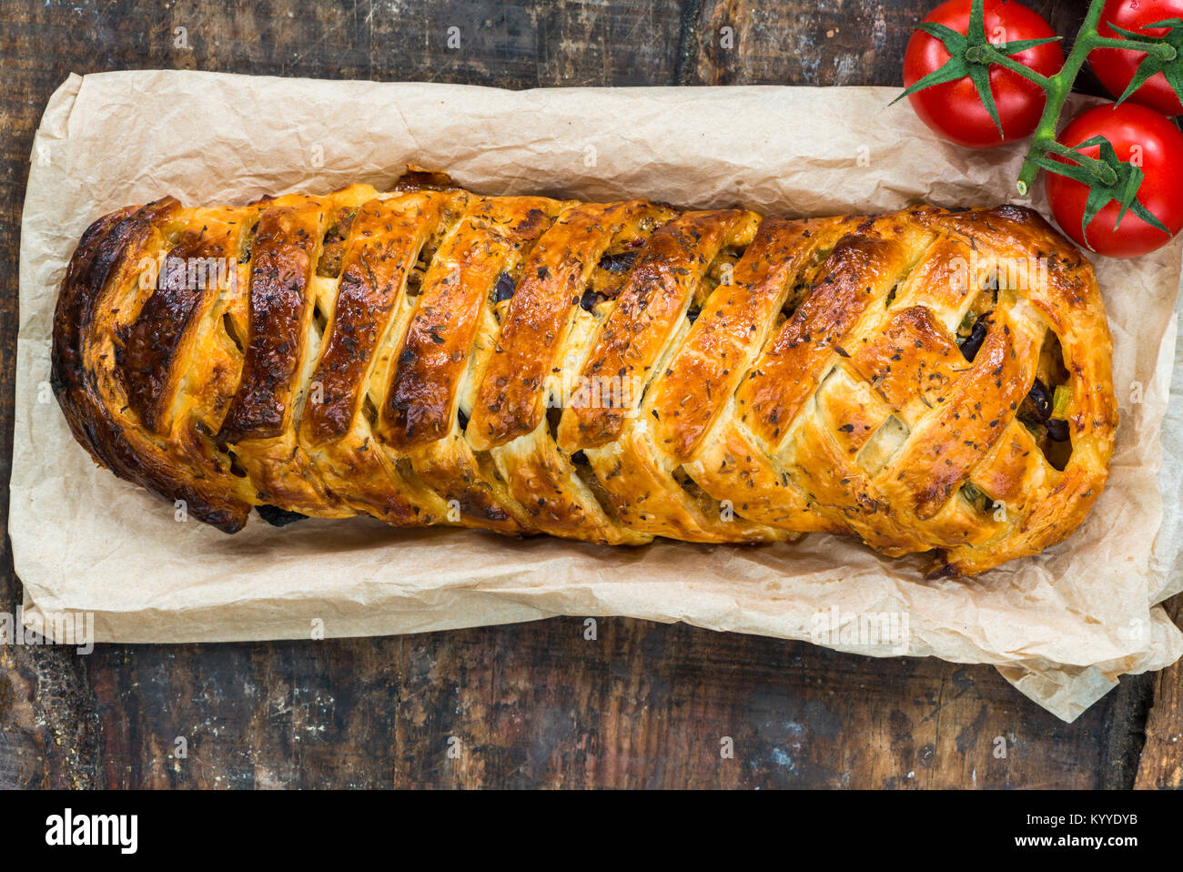 Pork roll spicy sausage meat with chillies and beans in puff pastry