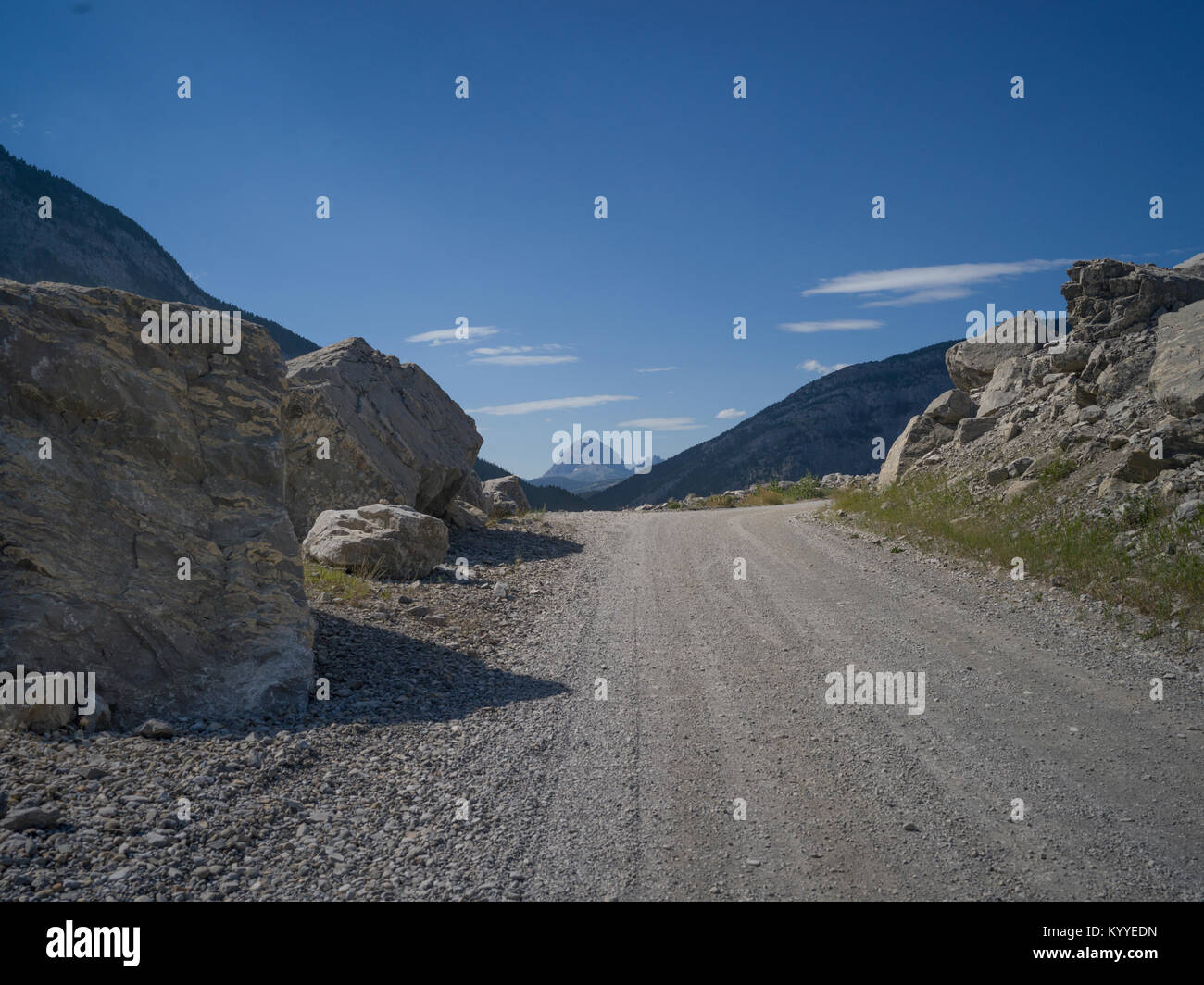 Dirt road passing through mountains, Frank Slide, Kananaskis Country, Southern Alberta, Alberta, Canada Stock Photo