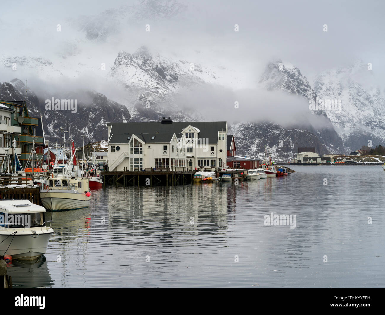 Boats at harbor with mountain in the background, Henningsvaer, Austvagoy, Lofoten, Nordland, Norway Stock Photo