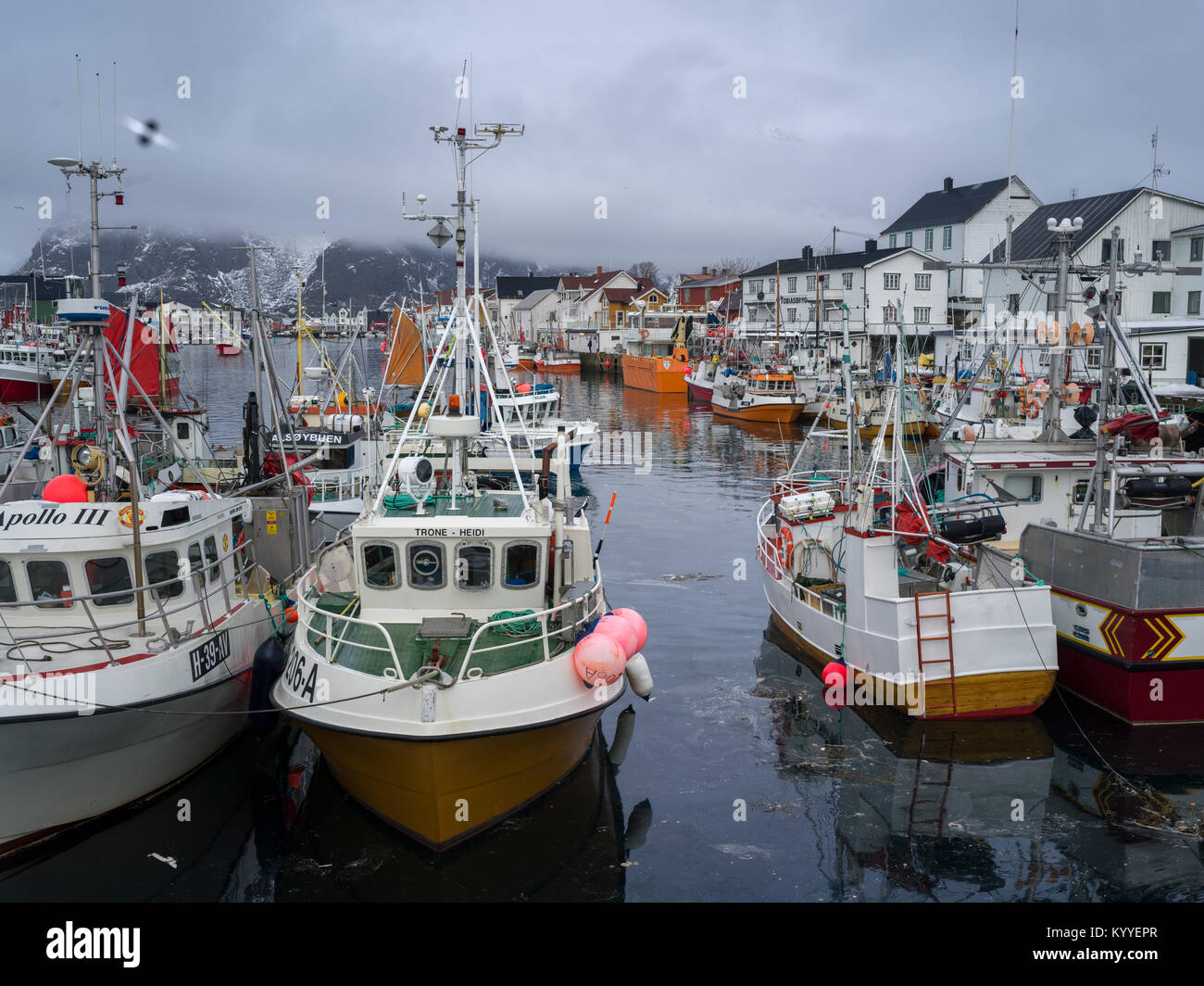 Boats at harbor with mountain in the background, Henningsvaer, Austvagoy, Lofoten, Nordland, Norway Stock Photo