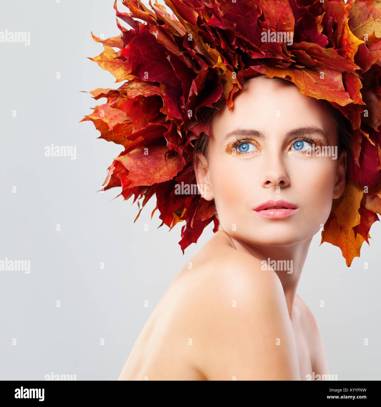 Autumn Beauty. Beautiful Woman in Wreath of Fall Leaves Stock Photo