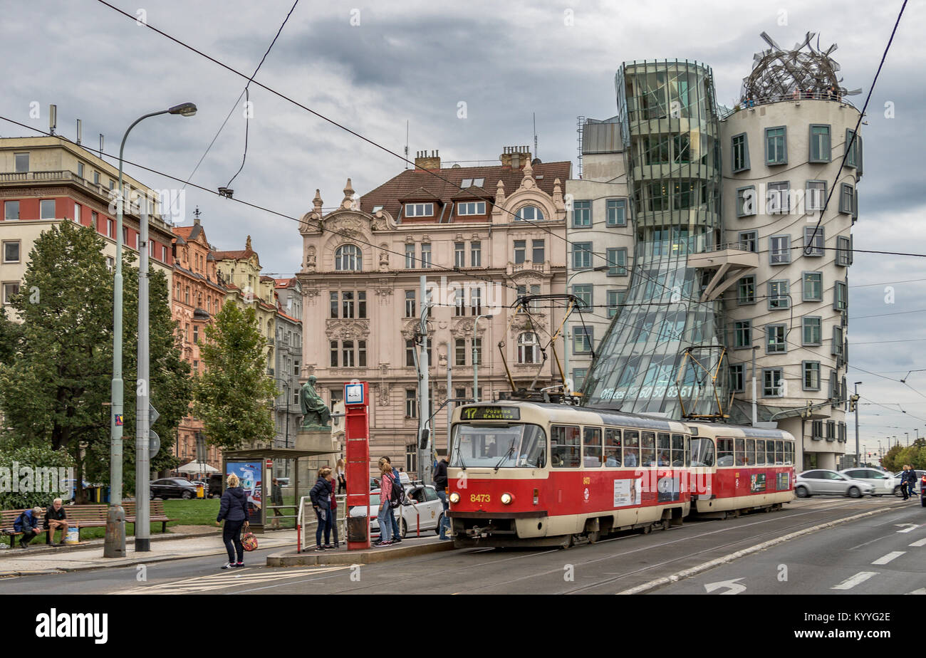 A tram passes in front of  The Dancing House, a landmark building housing The Dancing House Hotelin Prague with a highly original design, Prague Stock Photo