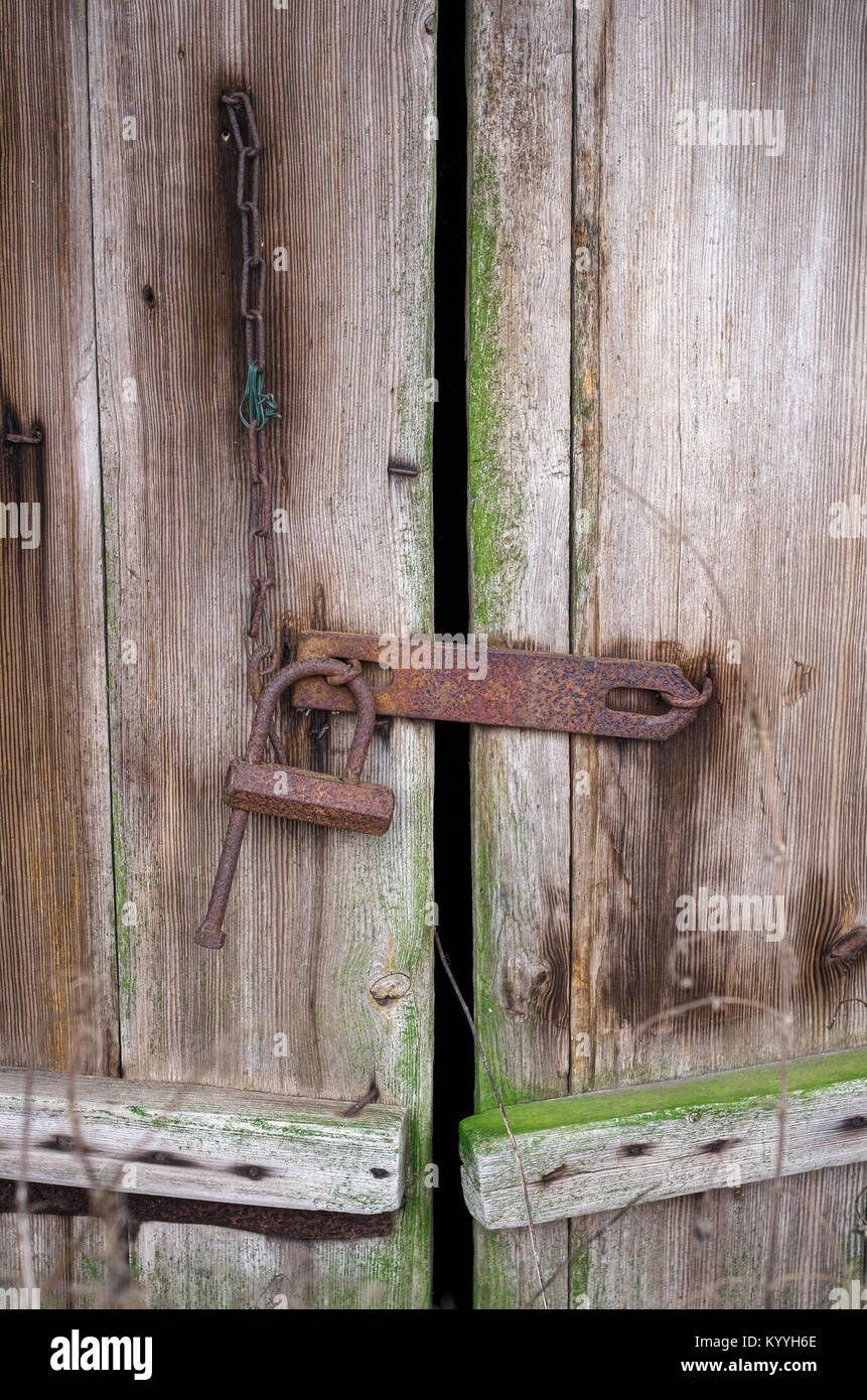 rusty padlock on the old barn door belarusian village Stock Photo - Alamy