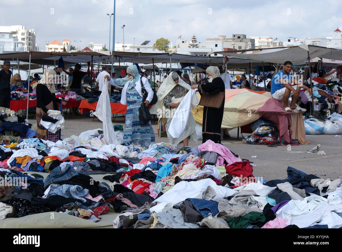 Tunisian women shopping for clothes in Monastir flea market, Monastir, Tunisia Stock Photo