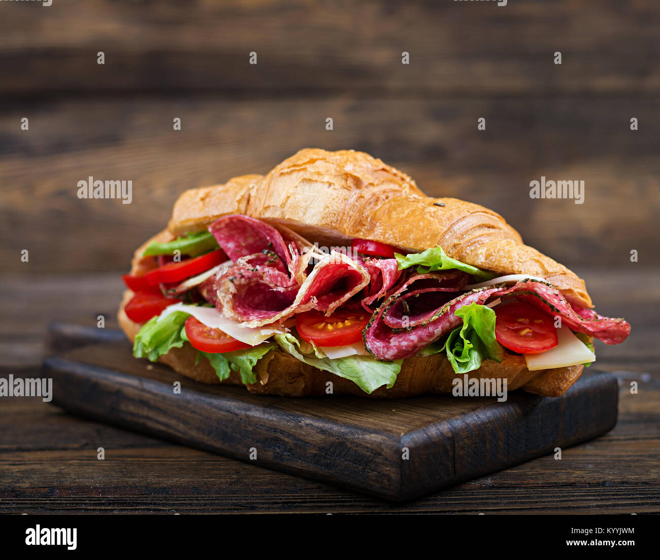 Tasty breakfast. Appetizing croissant with salami and, cheese and