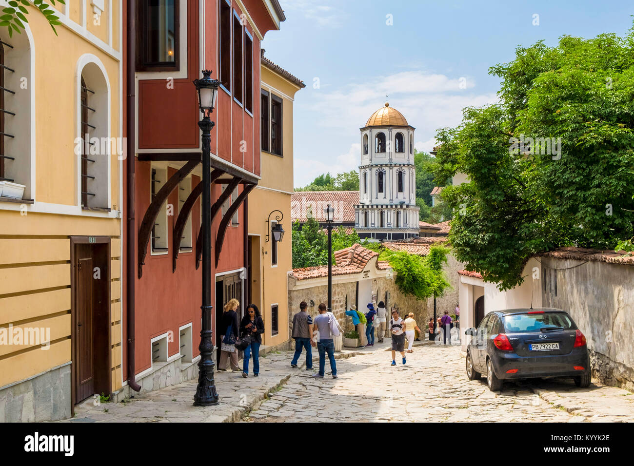 Tourists in Plovdiv Old Town with the Church of St Constantine and Helena in the background, in Plovdiv, Bulgaria, Europe Stock Photo