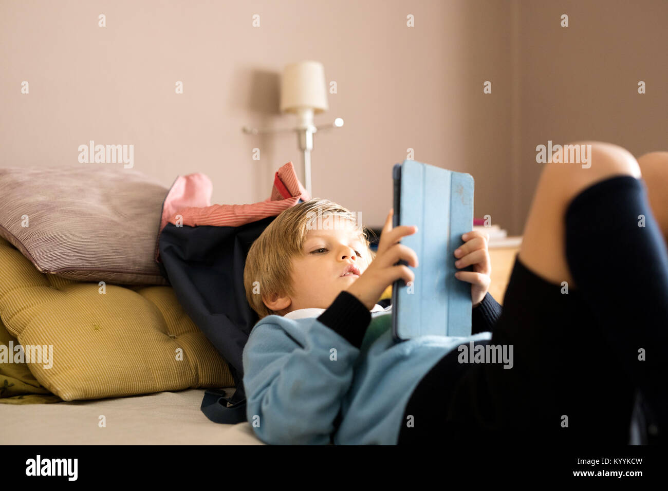 Boy using digital tablet in the bedroom in the bedroom Stock Photo