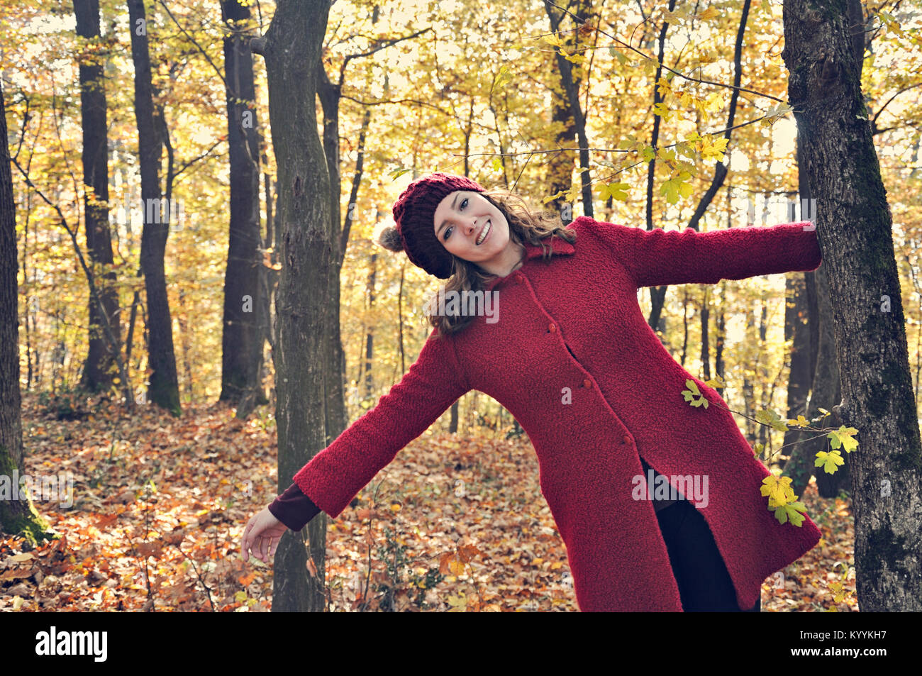 Portrait of happy young woman outdoors in forest Stock Photo