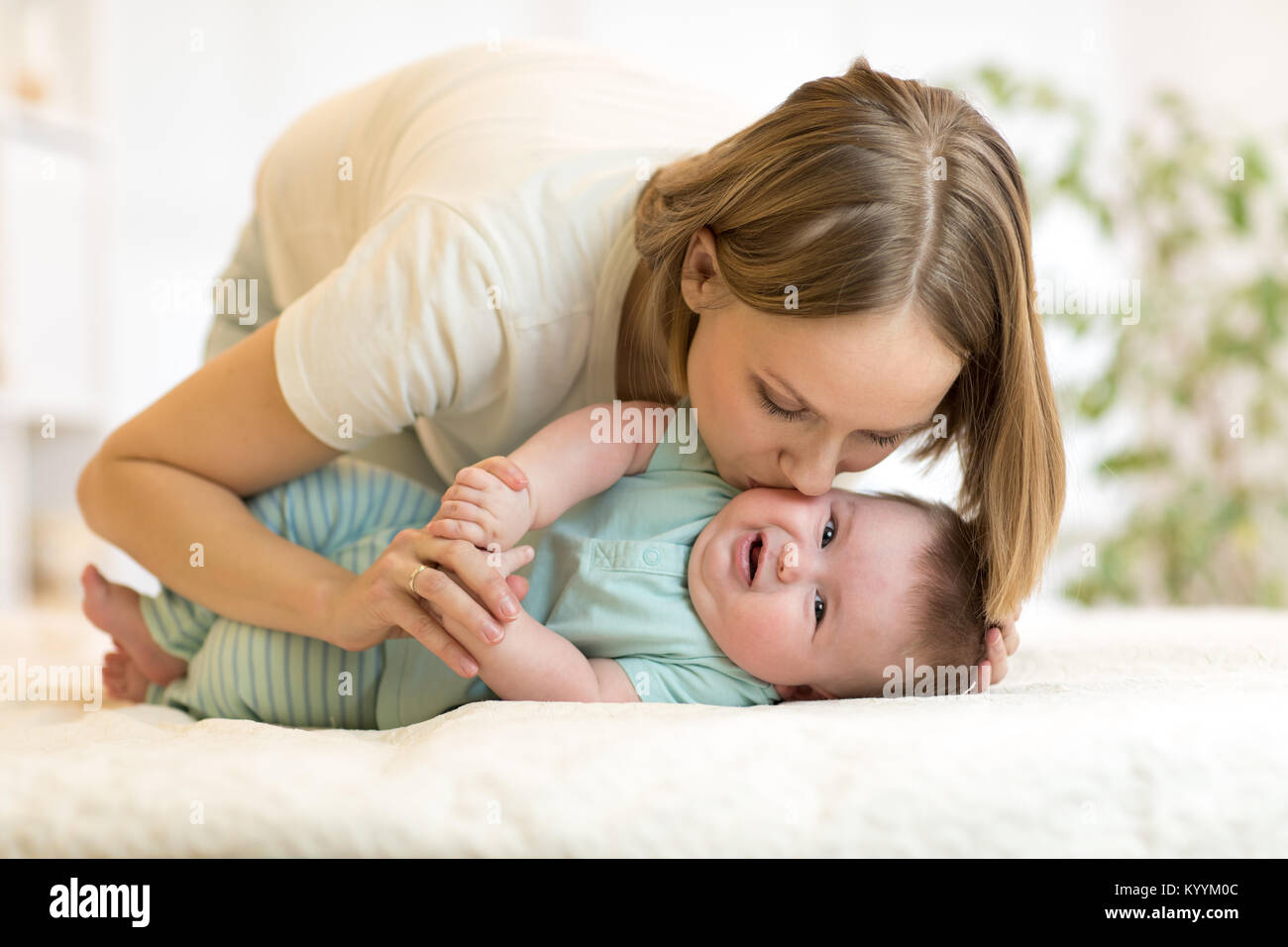 Happy loving family. Mom playing with her baby. Stock Photo
